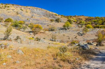 Fototapeta na wymiar forest and rocks on scenic mountains of Kungurbuka ridge near Karankul in autumn (Tashkent Region, Uzbekistan)