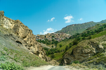 Village of Chokh in Dagestan. Facades of houses located in tiers on a steep slope, summer landscape.