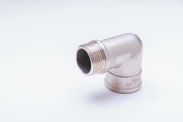 A water tap and a hose in a metal braid. Accessories for the repair of water supply.