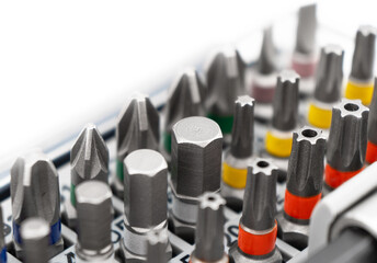 Mechanics tool set isolated on white background. Macro shot mechanics tool kit pattern. Set of working tools and bits. Screwdriver metal bits. Head different size hex drive