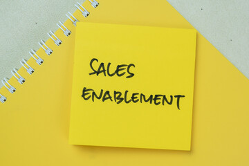 Concept of Sales Enablement write on sticky notes isolated on Wooden Table.
