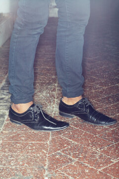 Shoes, legs and closeup of man feet by brick floor for an elegant, stylish and trendy outfit. Fashion, footwear and zoom of male person with luxury, classy and expensive style with jeans by pavement.