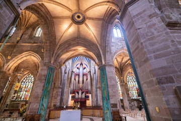 Fototapeta na wymiar Edinburgh a majestic cathedral adorned with vibrant stained glass windows and rows of seating