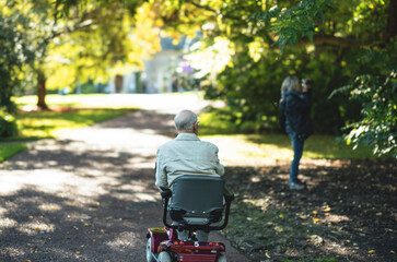 Edinburgh an elderly man enjoying a leisurely ride on a mobility scooter