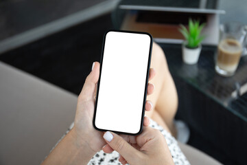 female hands hold phone with isolated screen in cafe office