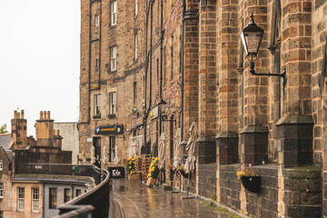 Edinburgh street photography on a rainy day brings the city to life. Cobblestone streets, colorful...