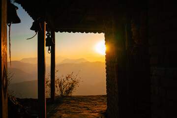 Serenity at Sunset: An idyllic view of the setting sun from an old rustic pavilion, with the...