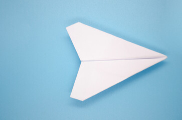 Top view of white airplane on light blue background with customizable space for text. Copy space concept
