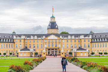 KARLSRUHE, GERMANY - July 29 2023: Front view on the Karlsruhe Palace with some tourists making short in the front of palace. - obrazy, fototapety, plakaty
