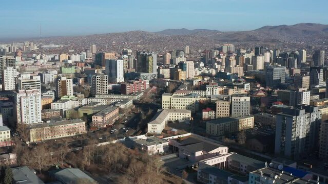 Drone footage of Ulaanbaatar on spring day. The capital of Mongolia. Hills in the background. Ulaanbaatar, Mongolia - 05 10 2022. 