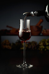 Brown herbal liquor or rum is poured from a vintage bottle.