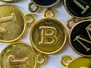 ld initial 'B' pendant in the middle of several letters