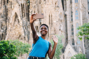African woman waving while doing video call visiting a Church