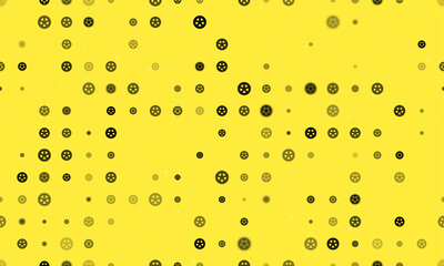 Seamless background pattern of evenly spaced black car wheel symbols of different sizes and opacity. Vector illustration on yellow background with stars