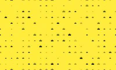 Seamless background pattern of evenly spaced black crown symbols of different sizes and opacity. Vector illustration on yellow background with stars