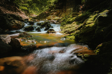 Waterfall or cascade with mountain river along hiking trail