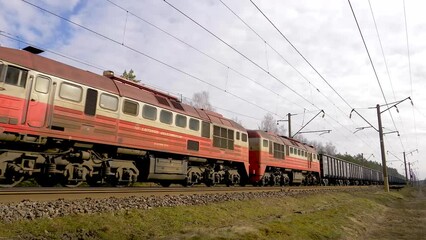 Footage of a passing freight train. Forests in the background. Lithuania, 05 10 2023