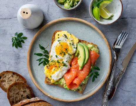 Breakfast Plate From Above Scrambled Eggs And Avocado With Salmon On A Sourdhough Toast