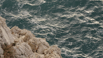 sea waves crushing over rocks with soft light