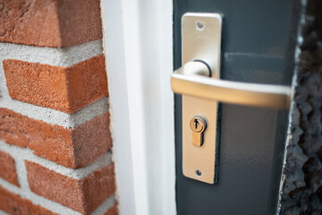Close-up of door lock and chrome metal handle.