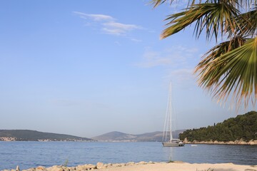 Beautiful view of tranquil sea and yacht on summer day