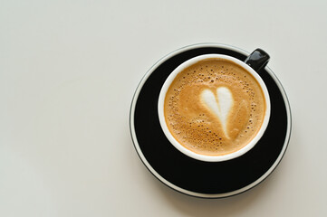 cup of fresh hot aromatic cappuccino with latte art in shape of heart