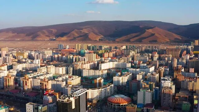Drone footage of Ulaanbaatar on spring day. The capital of Mongolia. Beautiful mountains in the background. Ulaanbaatar, Mongolia - 05 10 2022. 