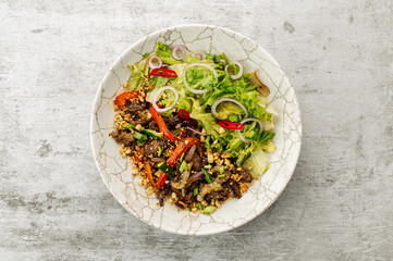 Thai meat salad with vegetables and greens