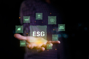 ESG icon on hand man. Net zero emission Idea innovation. Environmental, social,Governance. Green energy icon around it. Green Energy Renewable Sustainable concept. carbon neutrality in 2050.