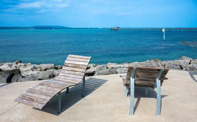 Two wooden empty deckchairs for sunbathing on the pier of Lake Constance - Bodensee - in swiss...