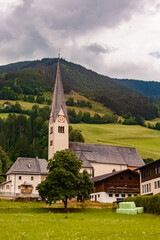 Fototapeta na wymiar Church on a cloudy summer day at Stuhlfelden, Upper Pinzgau, Zell am See , Salzburg, Austria