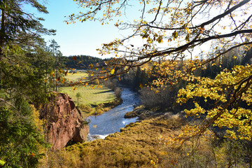 Zvartes rock and Amata river in autumn day