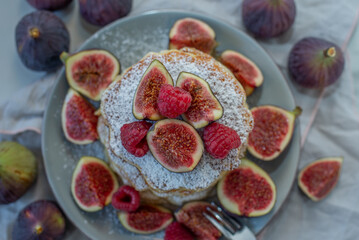 Fototapeta na wymiar Pancakes with raspberries, figs, yogurt,
