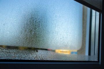  Indoor close-up of a leaky window with steam and condensate texture. - 669466185