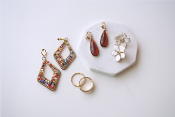 アクセサリー｜beautiful golden jewellery on white marble stone