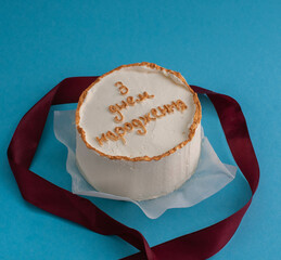 Bento cake in the shape of a circle with small red hearts in eco packaging. Image for websites about desserts, food,  Selective focus.