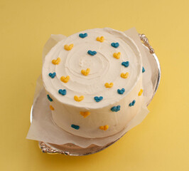 Bento cake in the shape of a circle with small red hearts in eco packaging. Image for websites about desserts, food,  Selective focus.