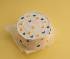 Bento cake in the shape of a circle with small red hearts in eco packaging. Image for websites about desserts, food,  Selective focus.