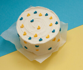 Bento cake in the shape of a circle with small red hearts in eco packaging. Image for websites about desserts, food,  Selective focus.