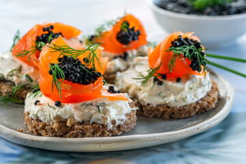 Cocktail canapes with smoked salmon, cream cheese and caviar on rye bread - gourmet party food.