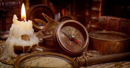 Vintage style travel and adventure. Vintage old compass and other vintage items on the table.