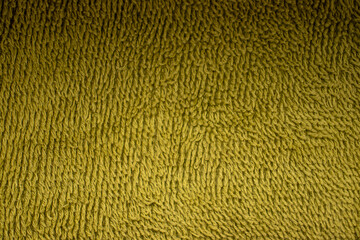  Close-up view of a green textured textile cloth backdrop.