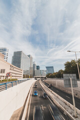 View of the four-lane highway running through Den Haag on a sunny day past the skyscrapers. Traffic in the Netherlands