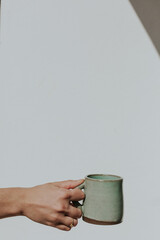 hand holding cup of coffee