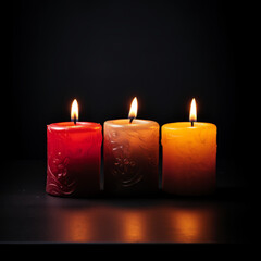 Fototapeta na wymiar Group of four candle lights, with dark background, with space for text
