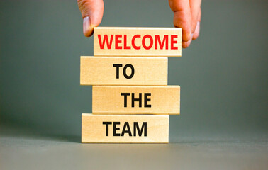Welcome to the team symbol. Concept words Welcome to the team on wooden block. Beautiful white table white background. Businessman hand. Business, motivational and welcome to the team concept. © Dzmitry