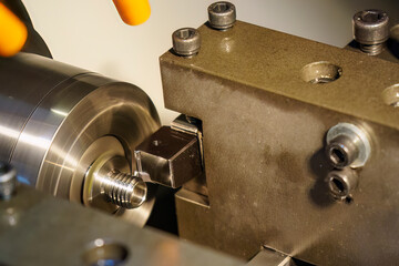 The multi-tasking CNC lathe machine swiss type thread cutting the metal pipe parts. - obrazy, fototapety, plakaty