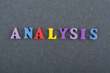 ANALYSIS word on black board background composed from colorful abc alphabet block wooden letters, copy space for ad text. Learning english concept.