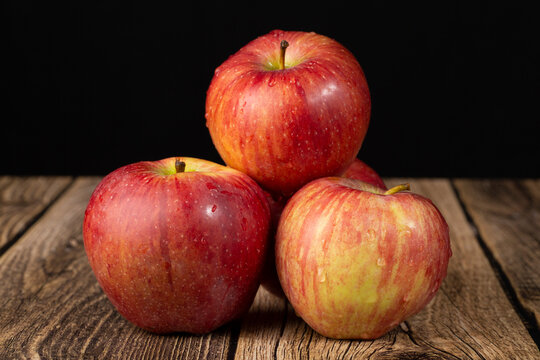 RED DELICIOUS apples are red on a dark background. Sale of fresh apples.