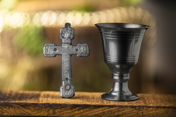 Eucharistic mass in the sacrament Eucharistic cup with Christian and religious cross.